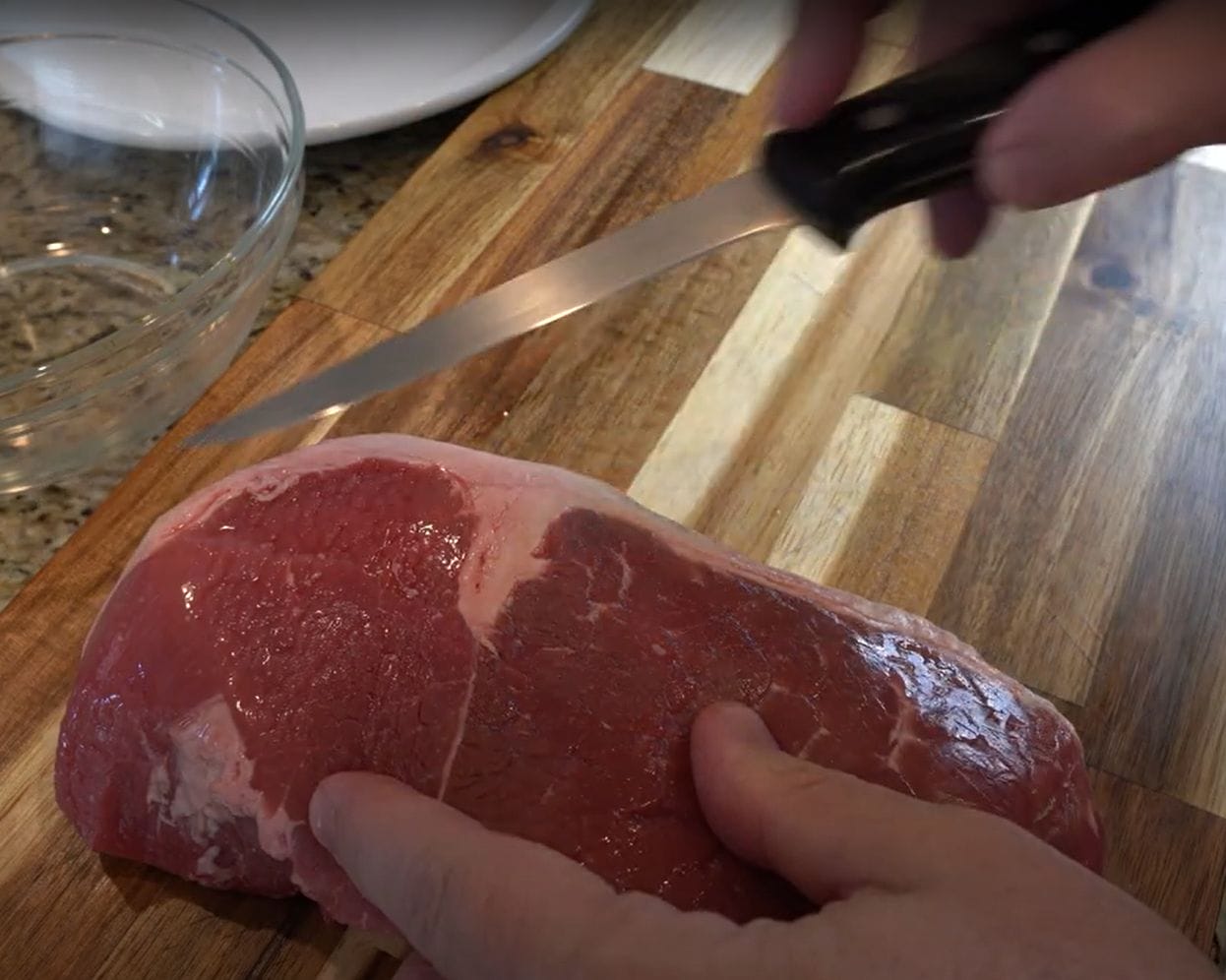 Trimming the fat off meat