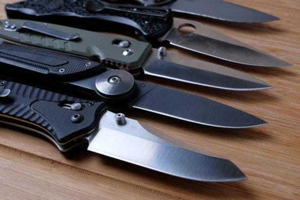 Thumbnail image of Folding,Knives,On,A,Wooden,Background.