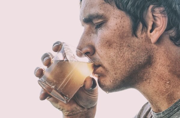 Thumbnail image of Man,Is,Drinking,Dirty,Water,From,The,Glass,Cup